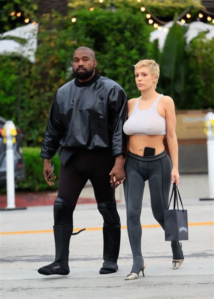 Bianca Censori holds blanket in front of her stomach outside Vegas hotel after Kanye West raps he wants 'another baby'