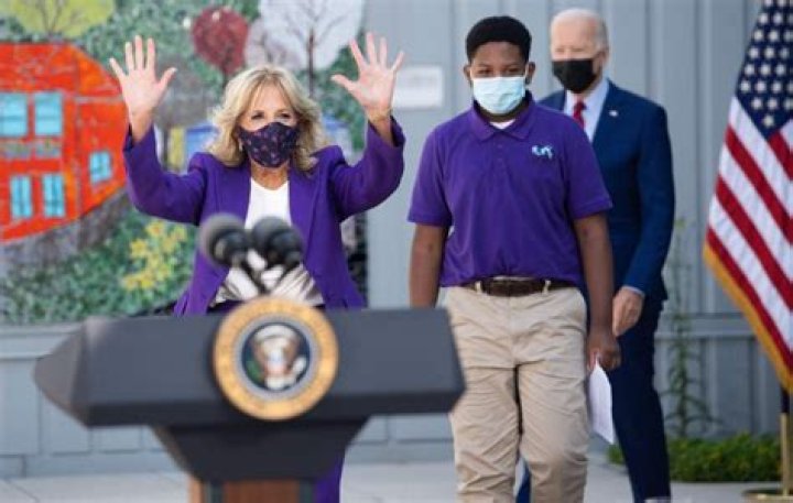 Biden awkwardly wanders away as Jill speaks at middle school before strutting back to the podium