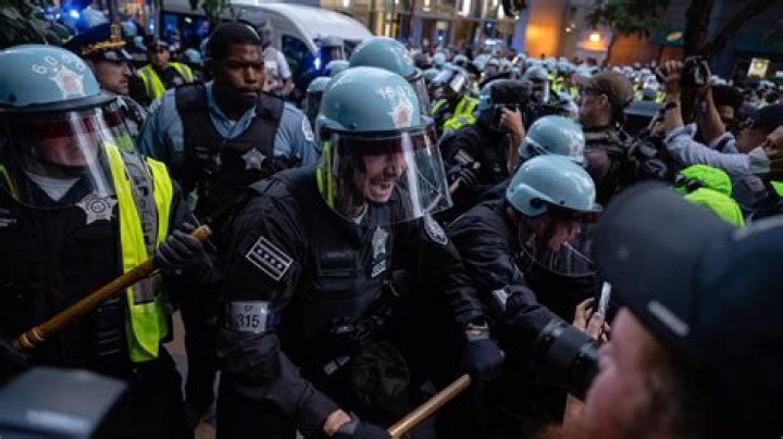 Black Lives Matter protesters ‘throw paint bombs’ at cops in riot gear ‘set off smoke grenades and break up march’