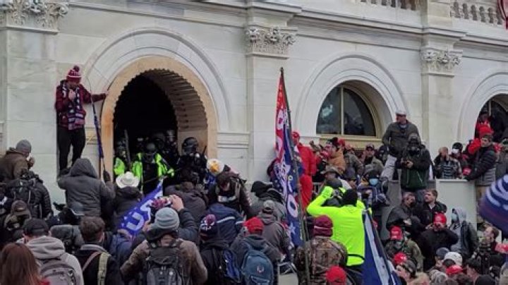 Shock moment Capitol rioter 'battered cop with HOCKEY STICK as officer lay on ground'