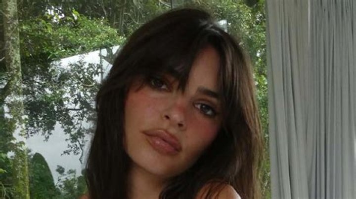 Emily Ratajkowski nearly suffers NSFW wardrobe malfunction as she lays in bed with her legs spread in tiny thong bikini