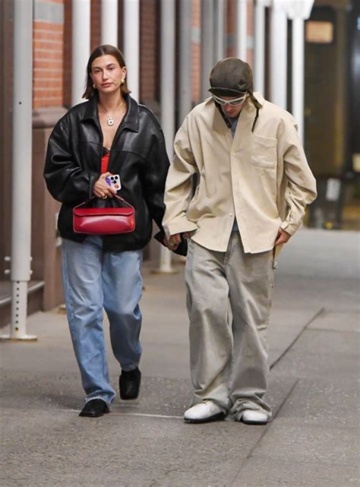 Hailey Bieber covers up in massive leather jacket and baggy jeans despite steamy summer weather on night out in NYC