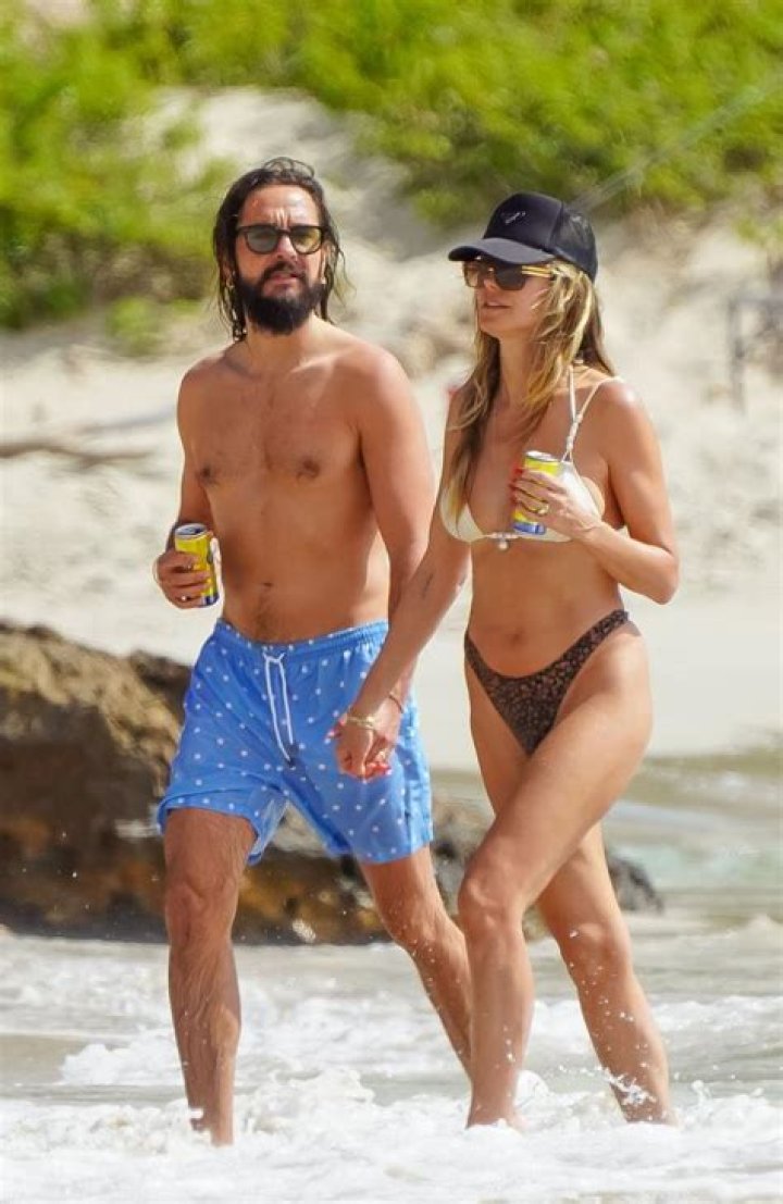 Heidi Klum ditches bikini top as she sunbathes next to husband Tom Kaulitz on stunning beach in St Barths