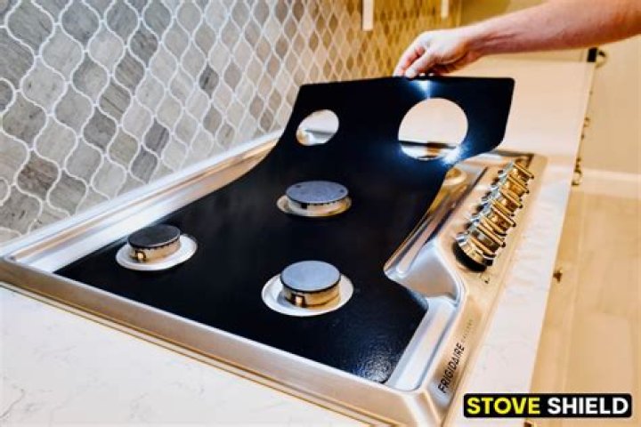 How do I lift my Frigidaire gas stove top?