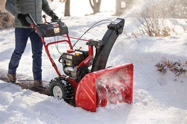 How do you clean a carburetor on a Troy Bilt lawn mower?