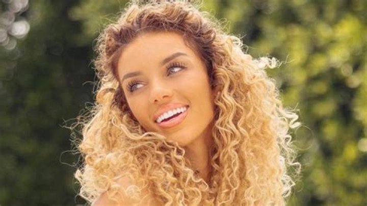 Jena Frumes lets luscious curls loose as she poses in cream bikini