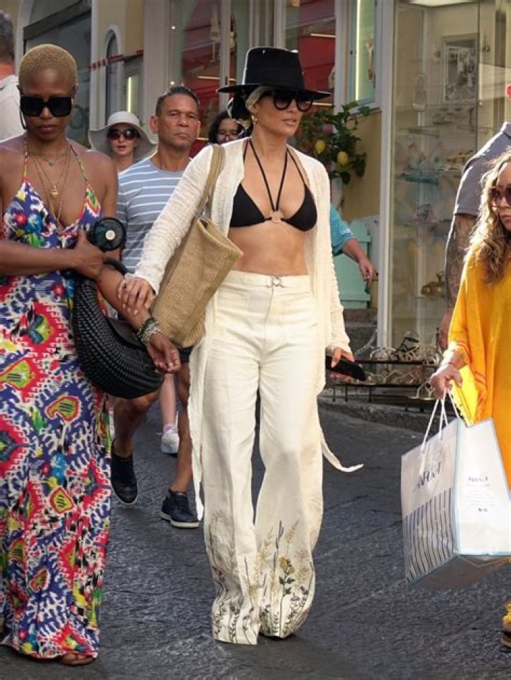 JLo, 54, shows off her real skin and almost slips out of black bikini in new photos while on getaway in Italy