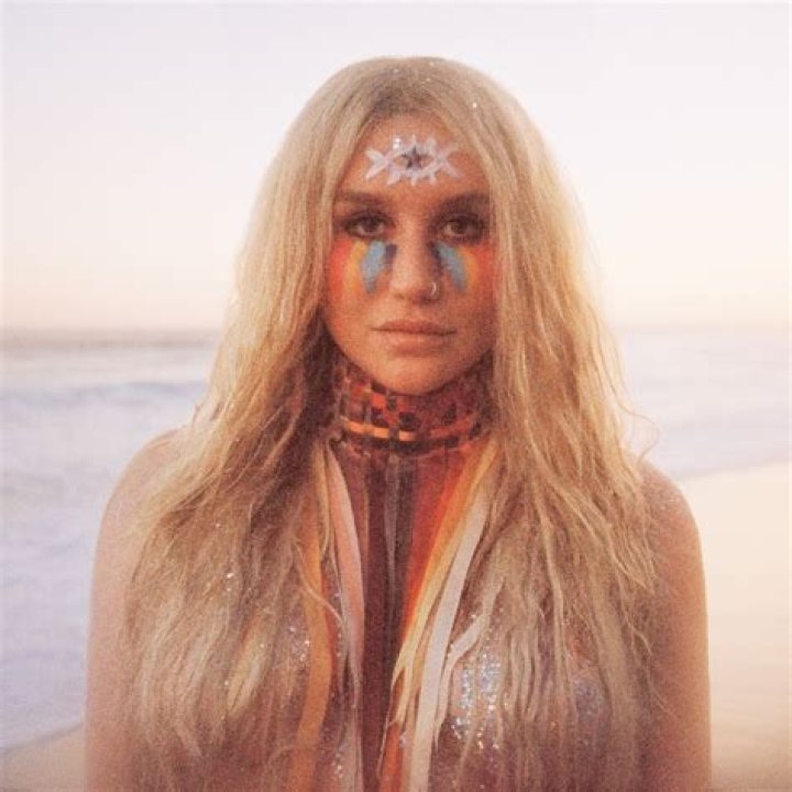 Kesha goes completely naked in a rushing river covered by only her latest album cover