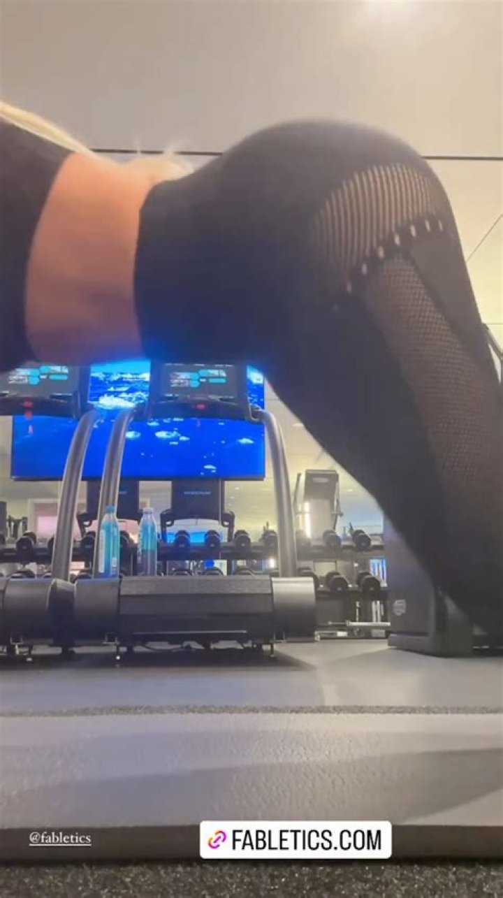 Khloe Kardashian grabs her butt and shows off her figure in tight leggings and sports bra for new video