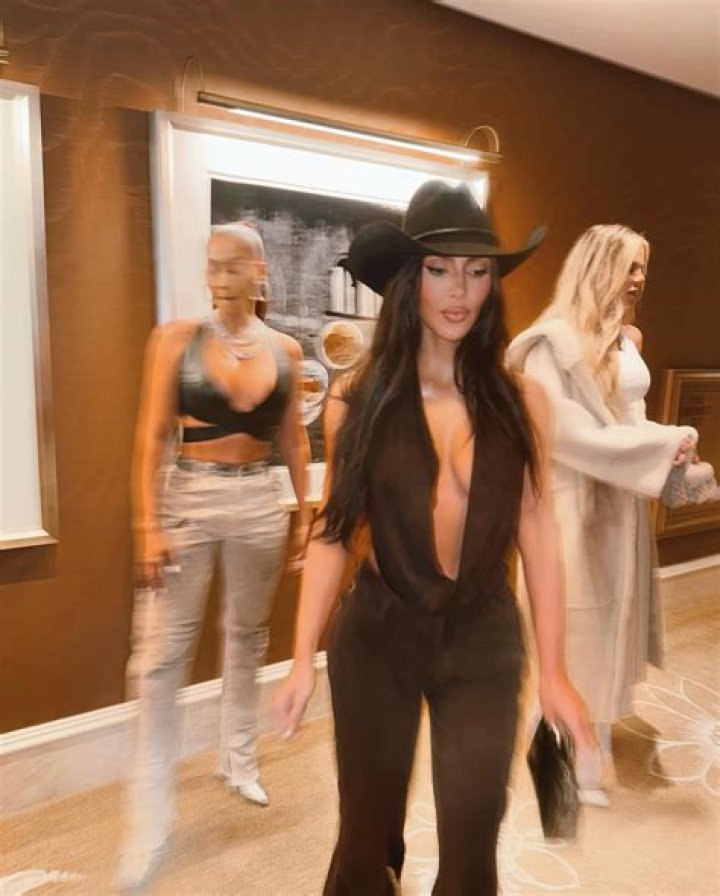 Kim Kardashian flaunts her cleavage in plunging top and cowboy hat as fans accuse her of copying Beyonce
