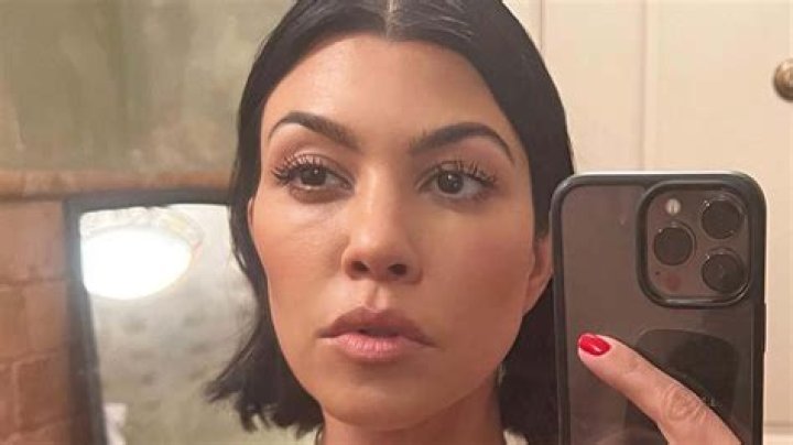 Kourtney Kardashian flaunts cleavage in lace lingerie top and makes out with husband Travis Barker during tour