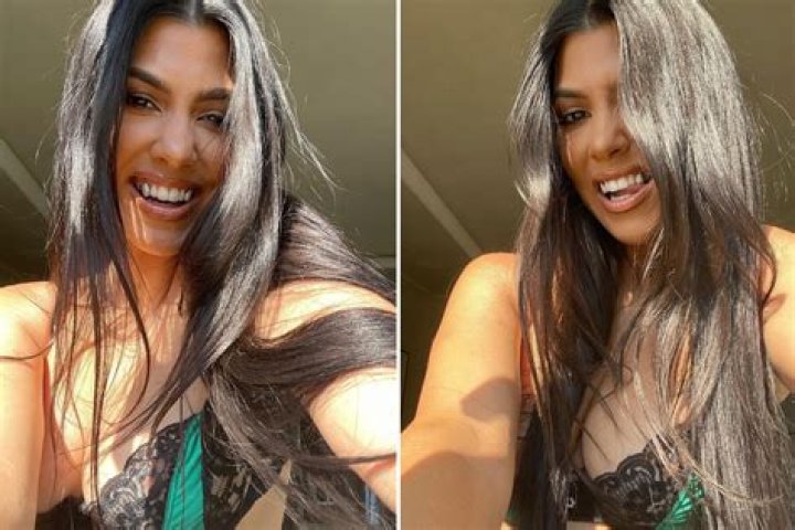 Kourtney Kardashian poses in just a bra & shows off her diamond-encrusted teeth in new photos