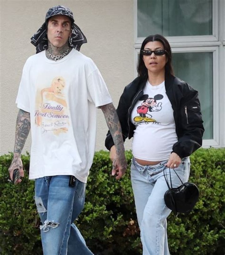 Kourtney Kardashian's baby bump spills over her unbuttoned jeans on stroll with Travis Barker as fans predict due date