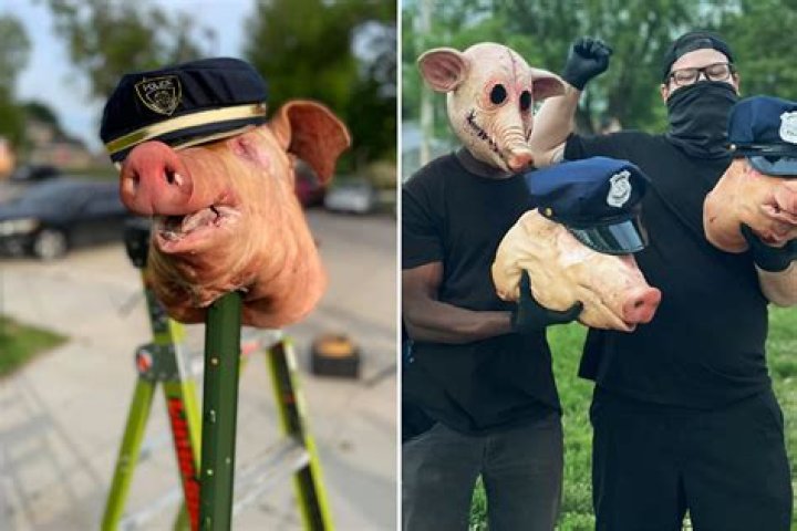 Protesters leave three severed PIG HEADS wearing cop caps outside Omaha police union as seven are arrested