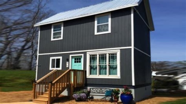 Inside my L-shaped tiny home built for $10k from Lowe's sheds - it has two floors and even a bedroom for my dogs