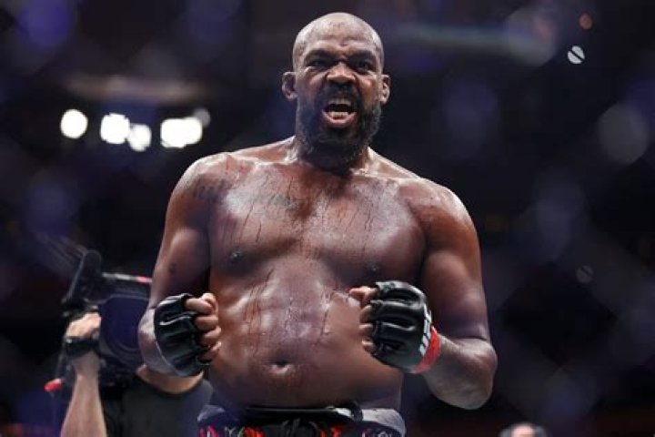 UFC star Jon Jones bizarrely trains in full camo gear with MACHINE GUN to help gain muscle in step up to heavyweight