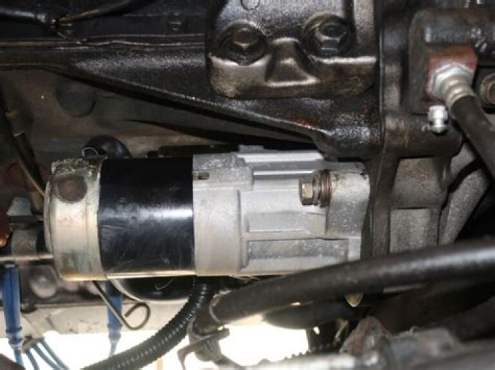 Where is the starter on a 2012 Jeep Liberty?