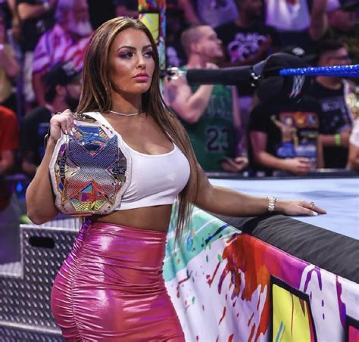 Ex-WWE stunner Mandy Rose shows off incredible figure in skin-tight dress as she rakes in cash after axe